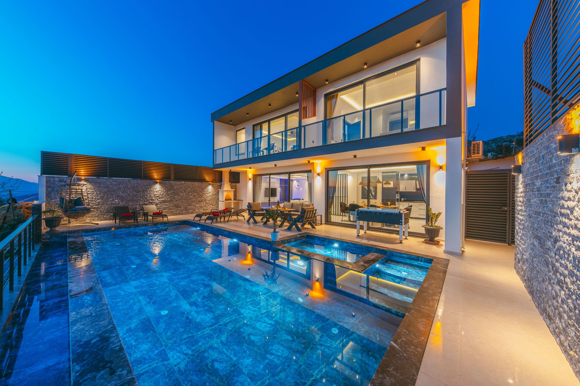 Contemporary residence with a pool at dusk