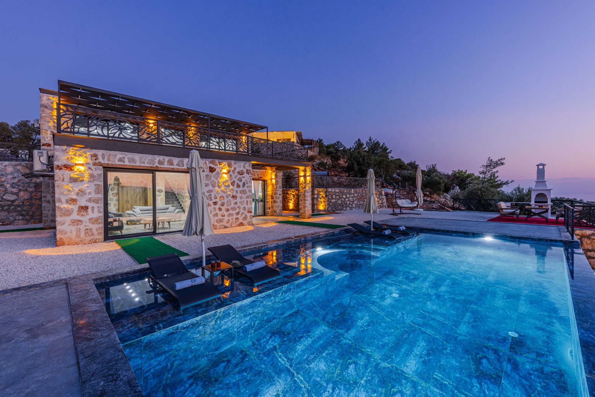 Stone villa with a pool at sunset