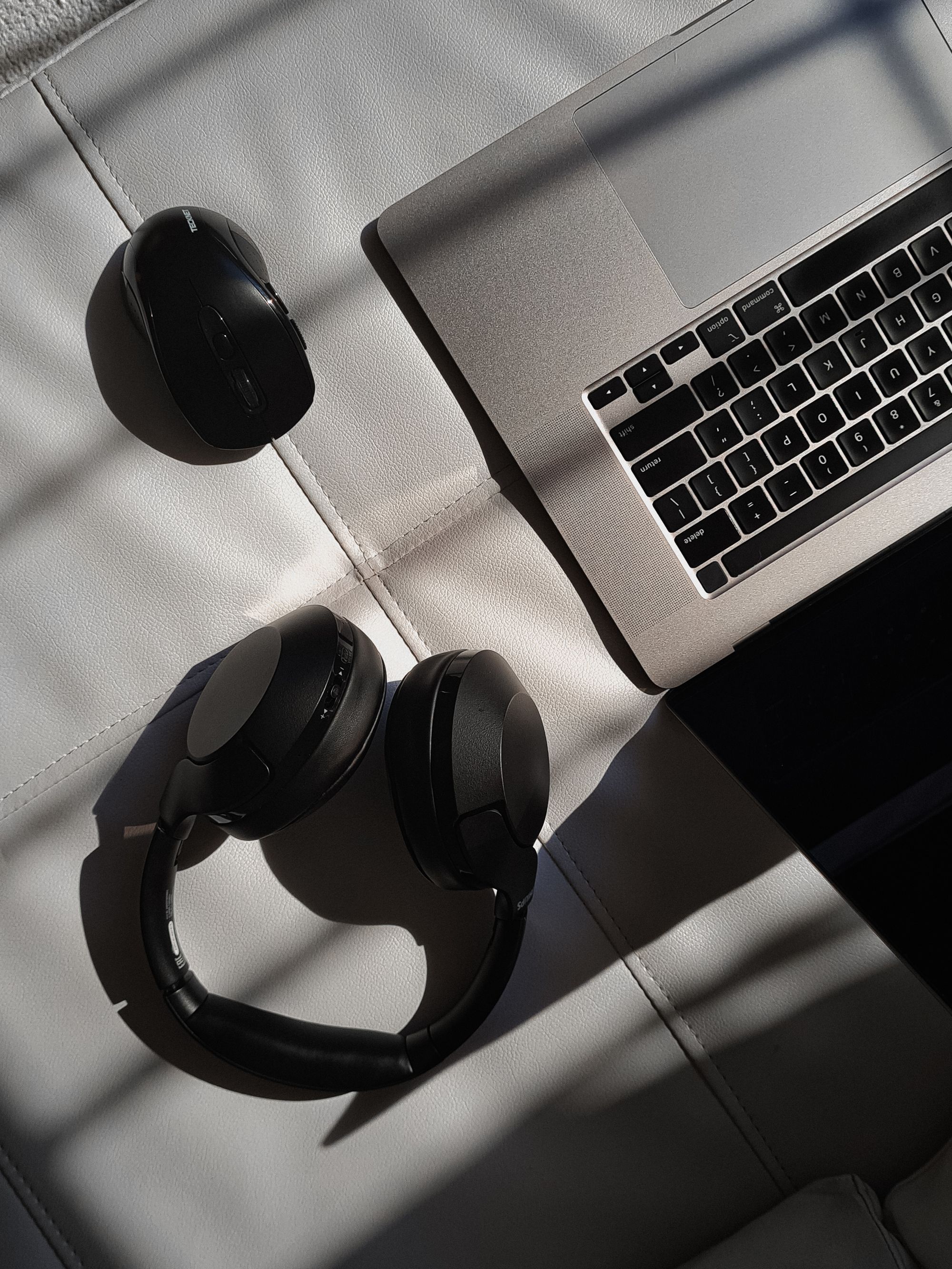 Headphones next to a laptop